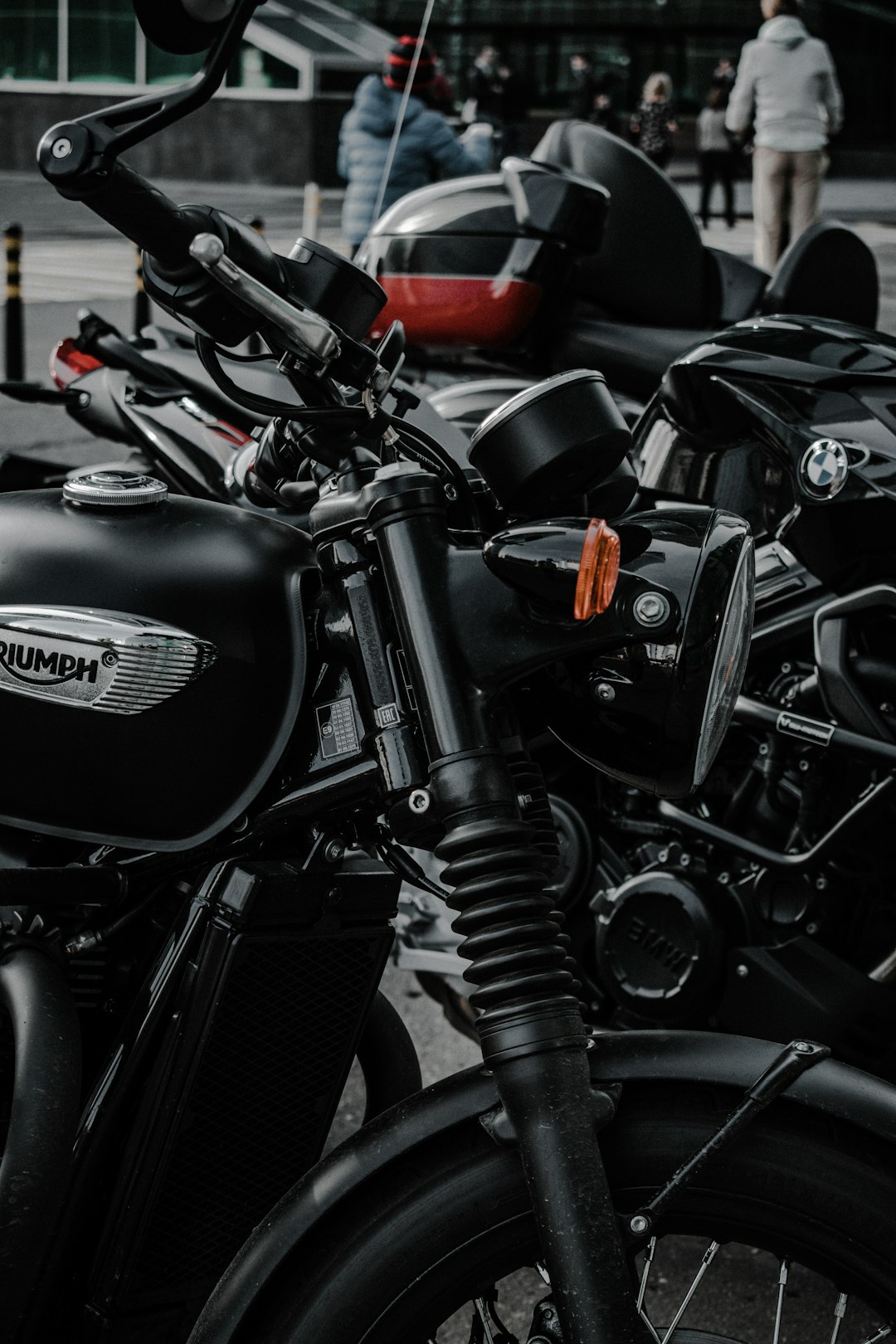 black and red motorcycle parked on parking lot during daytime