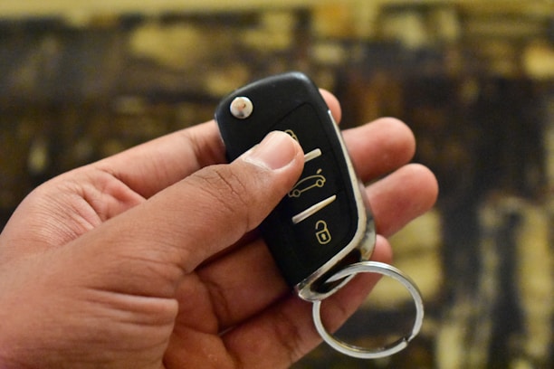 A skilled locksmith carefully programming a car key with specialized tools.