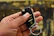 Close-up of a modern car key fob being programmed by a skilled locksmith.