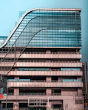 Business building outline in navy and gray illustrating corporate insurance.