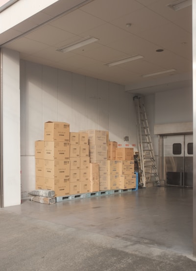 brown cardboard boxes on white floor tiles