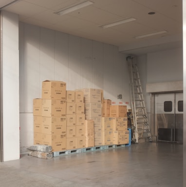 brown cardboard boxes on white floor tiles