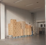 brown cardboard boxes on white floor tiles