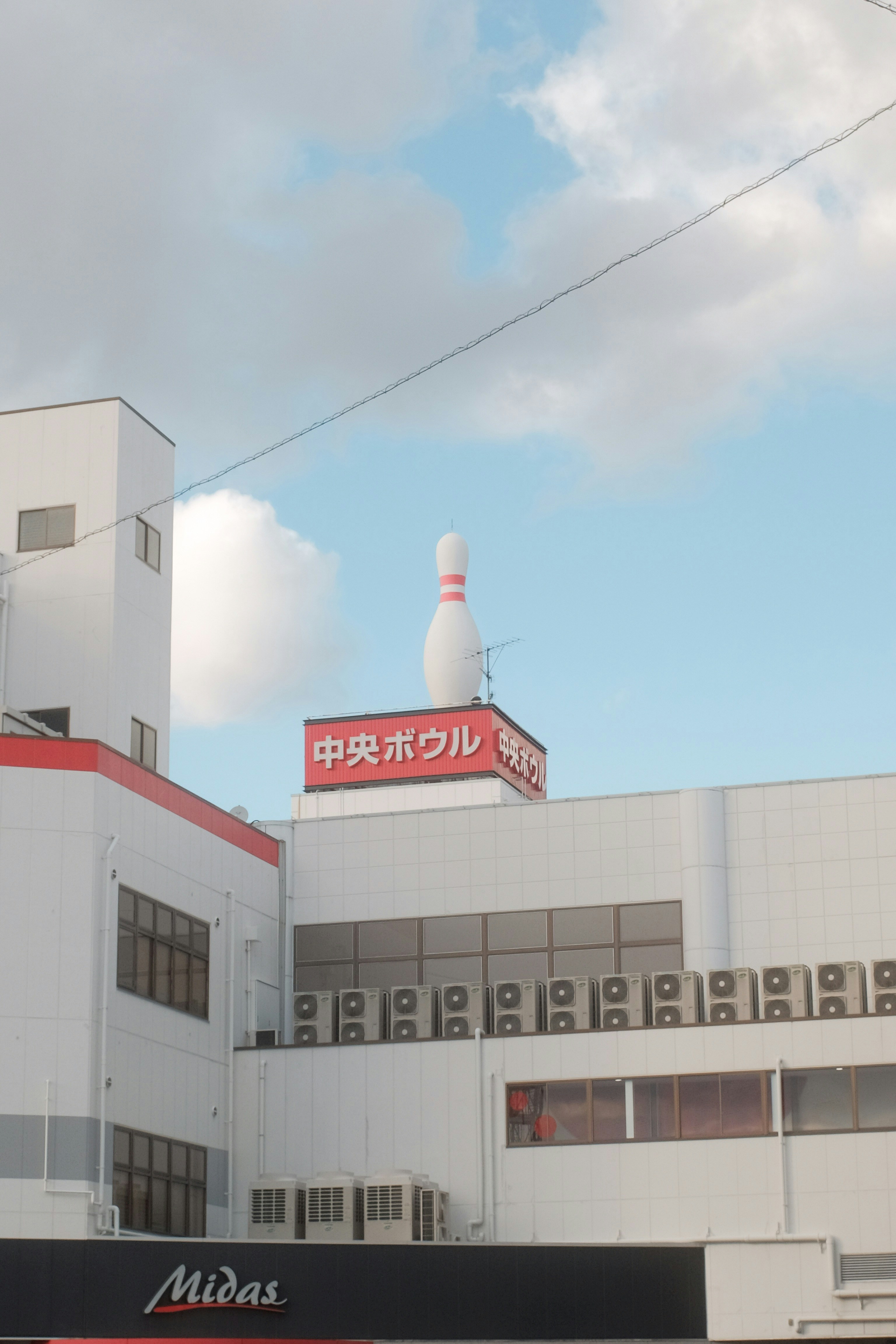 white and red concrete building under blue sky during daytime