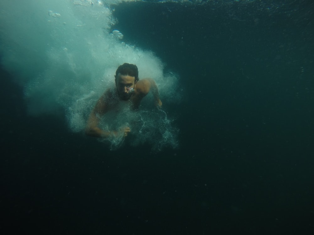 man in water with blue and white goggles