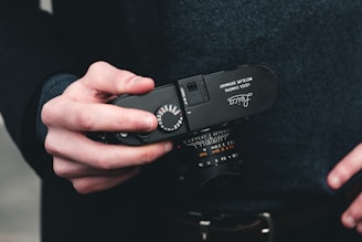 a person holding a camera in their hands