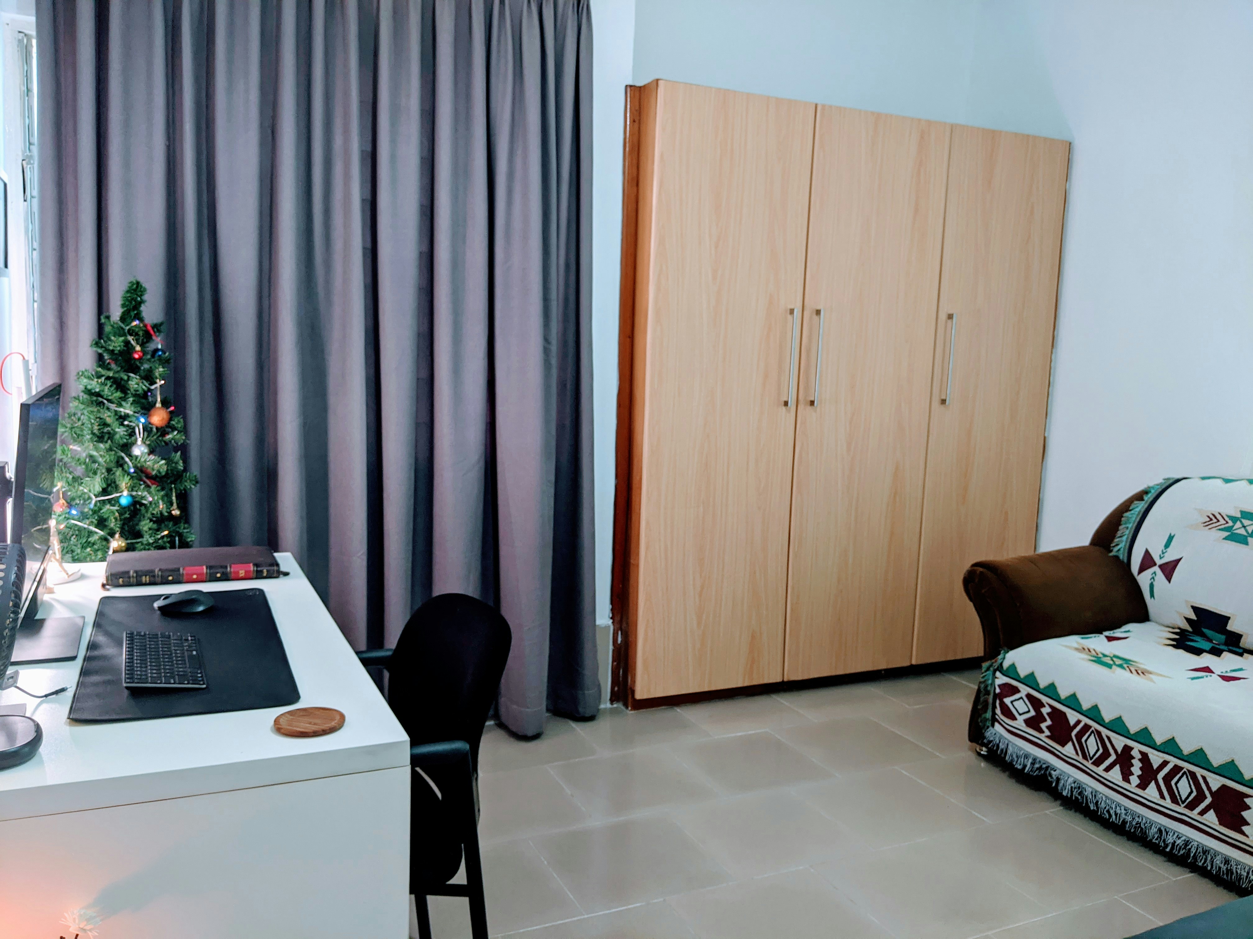 a living room with a computer desk and a chair