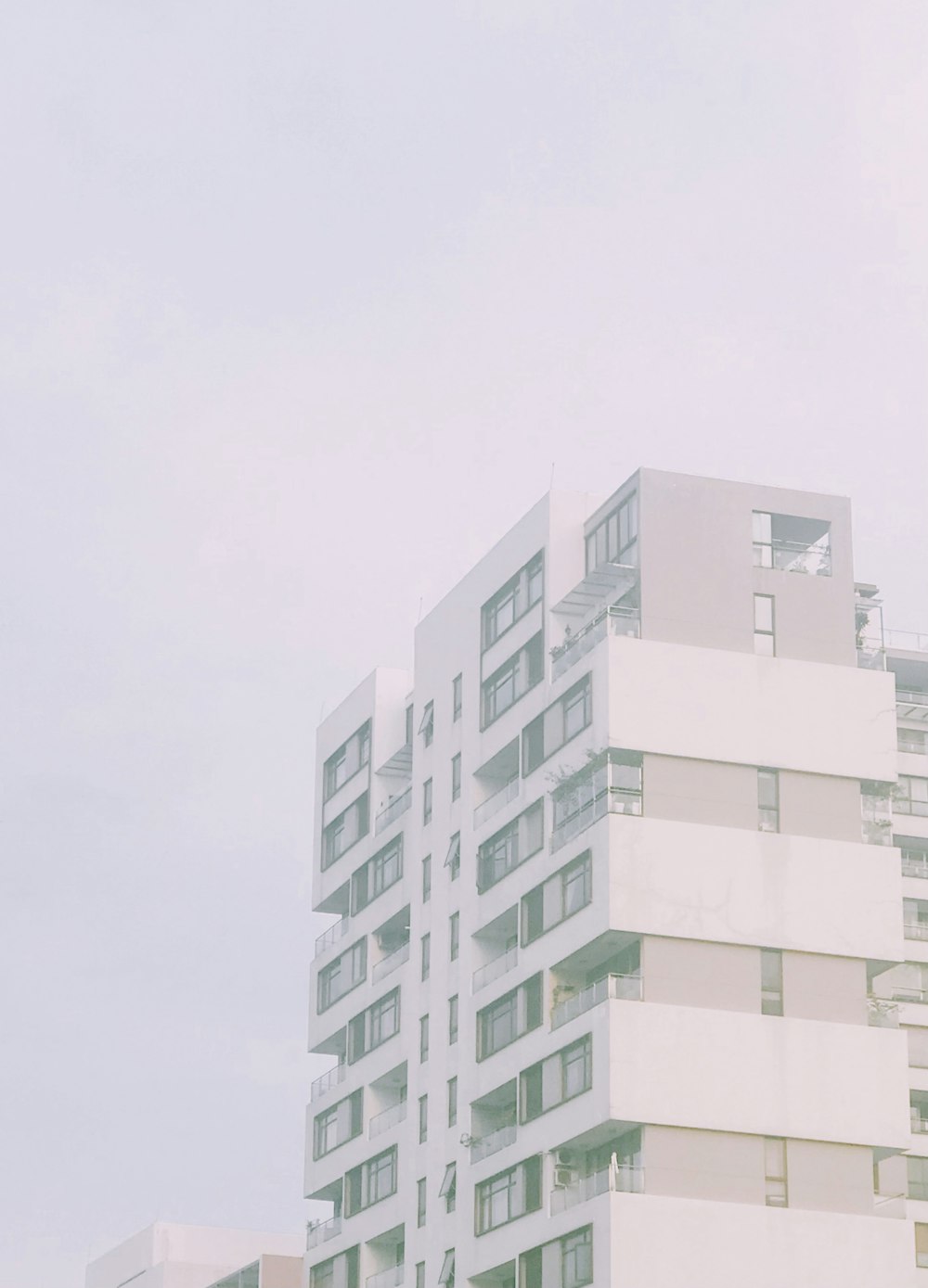 a tall white building sitting next to a tall white building