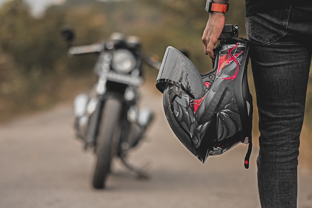 person in black leather jacket riding black motorcycle