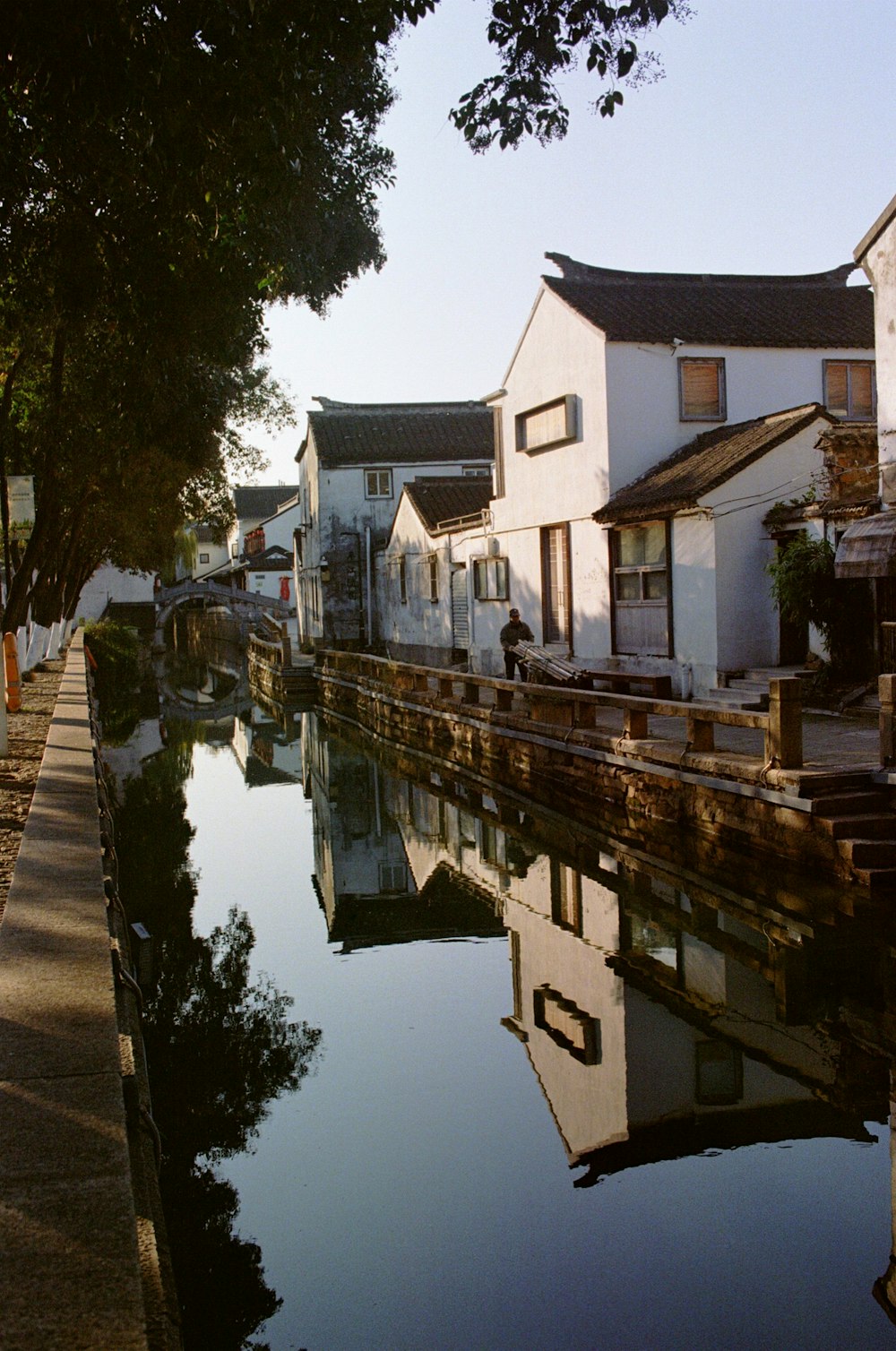 white and brown concrete house beside river during daytime