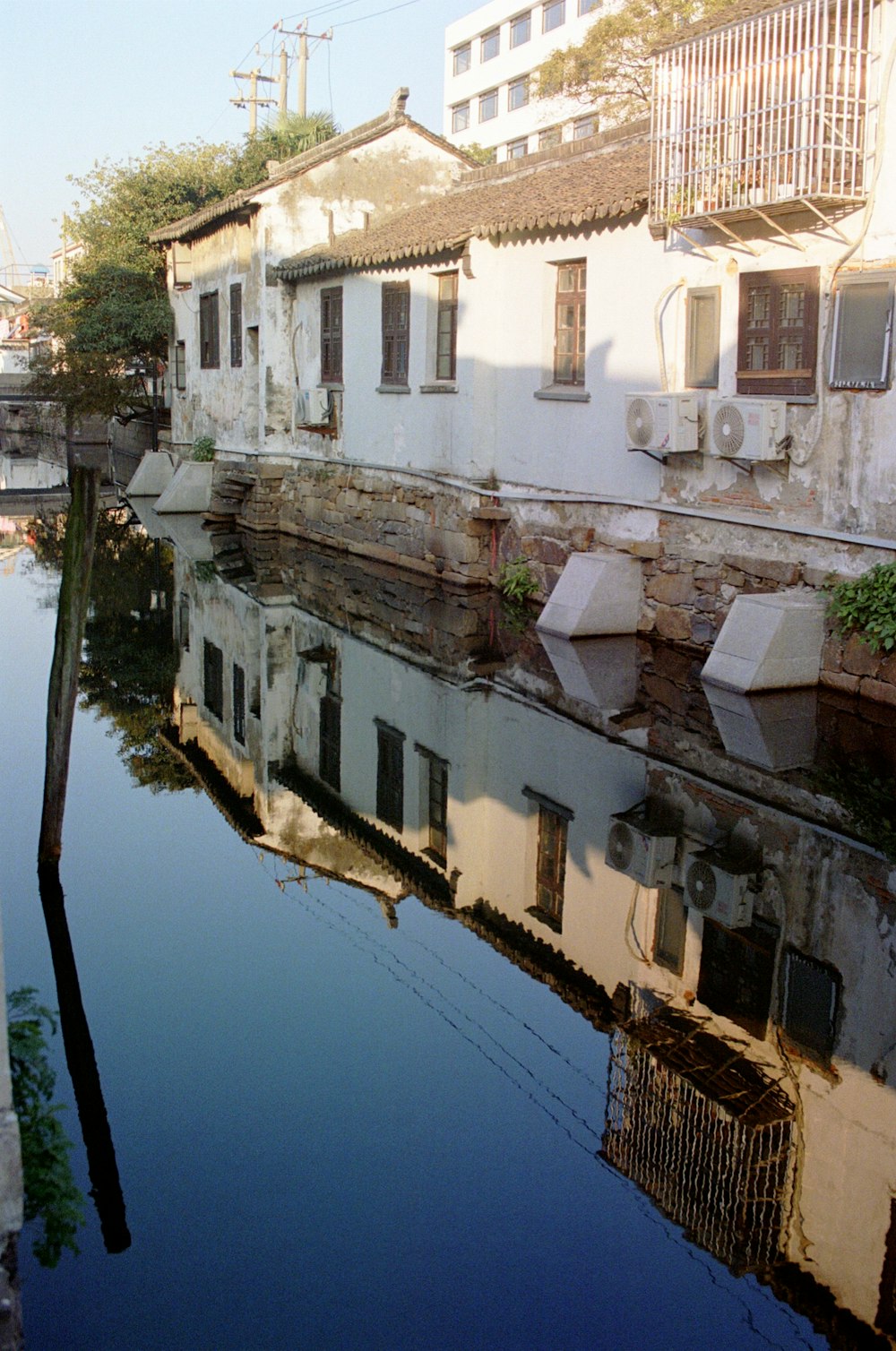 white concrete building beside body of water during daytime