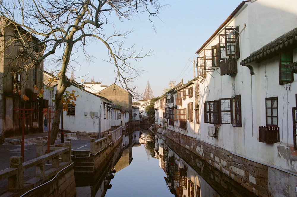 white concrete building beside river during daytime