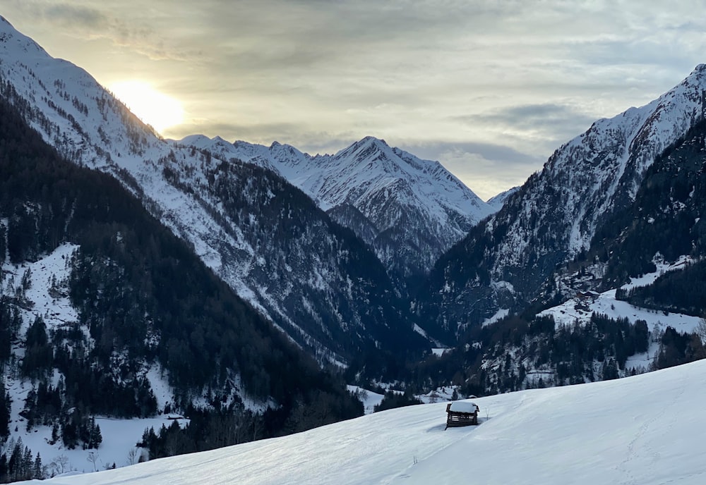 snow covered field and mountains during daytime