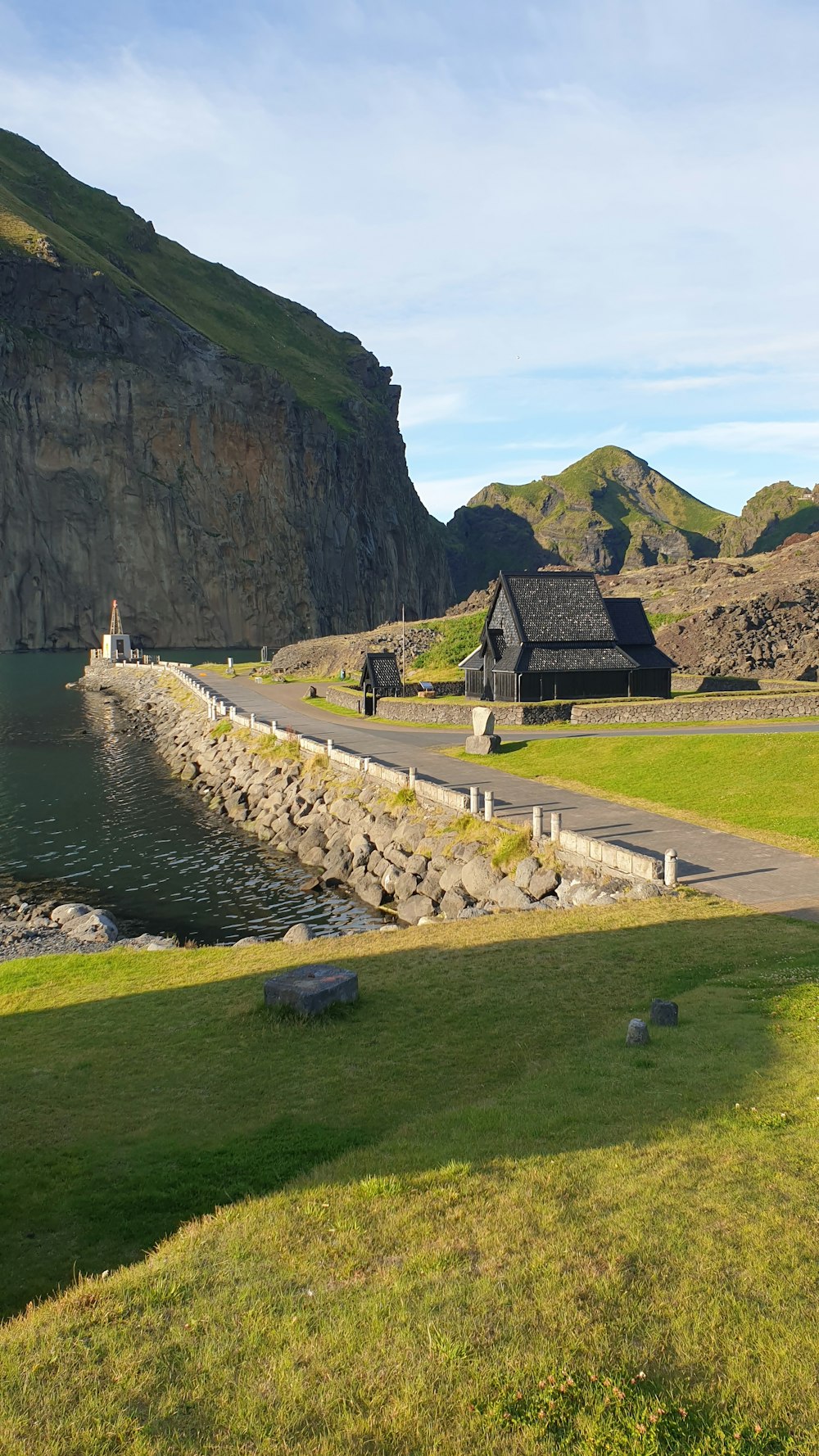 brown and gray house near body of water during daytime