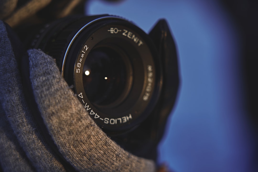 black nikon dslr camera on gray textile