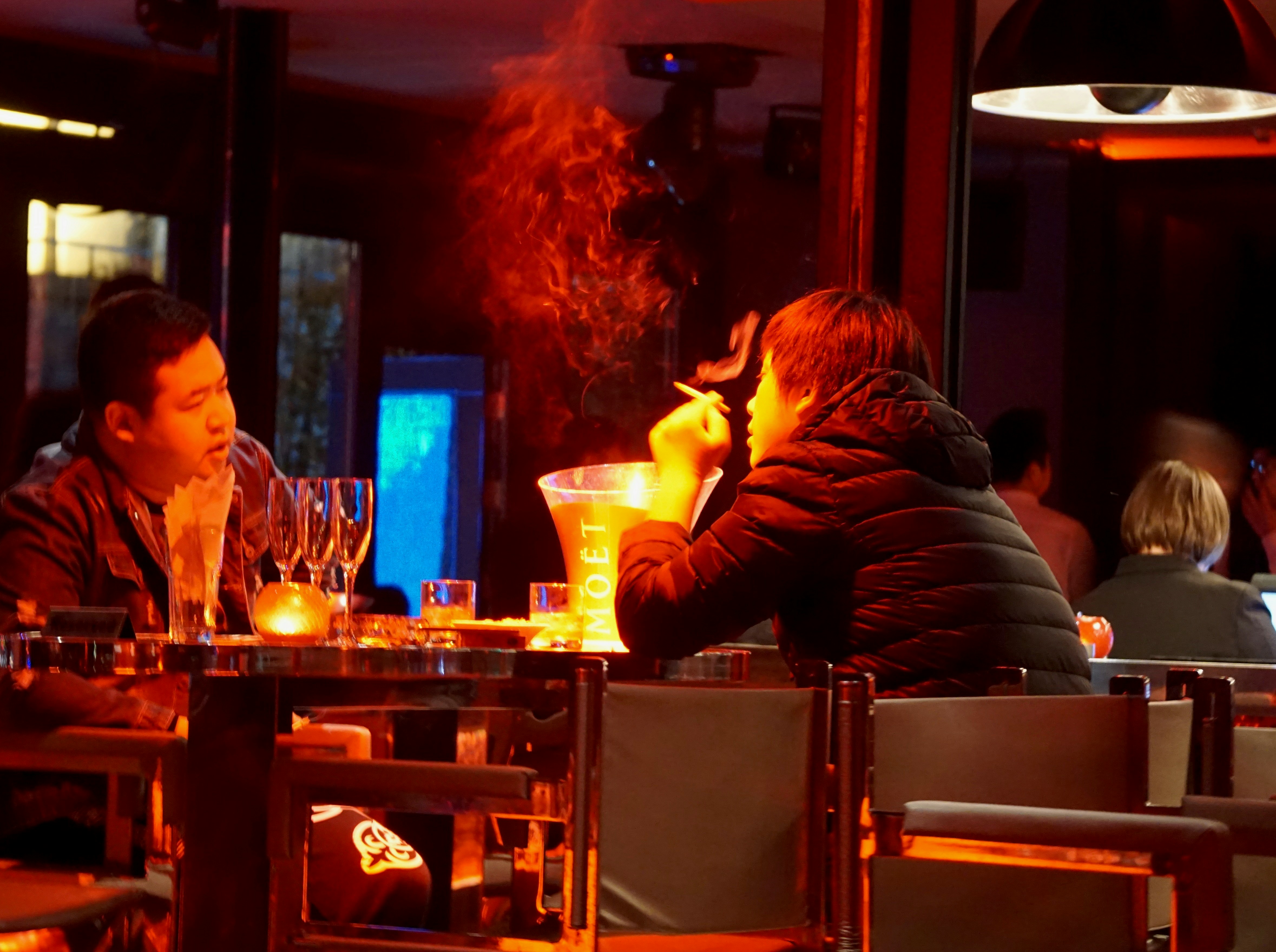man in black long sleeve shirt smoking