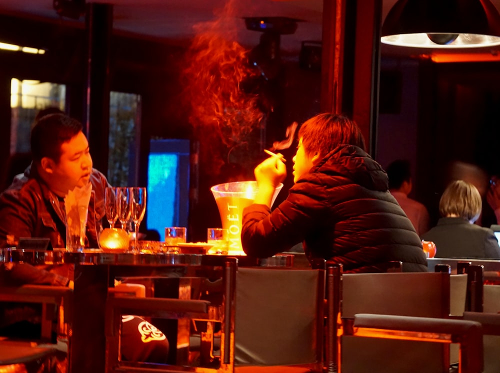 man in black long sleeve shirt smoking