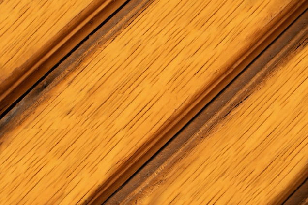Close-up of rich, large Tuscan wood planks laid beautifully in a warm, inviting interior space.