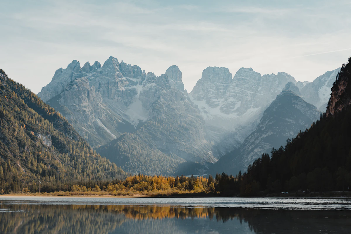 Frozen alpine lake beneath snow-covered Dolomite peaks