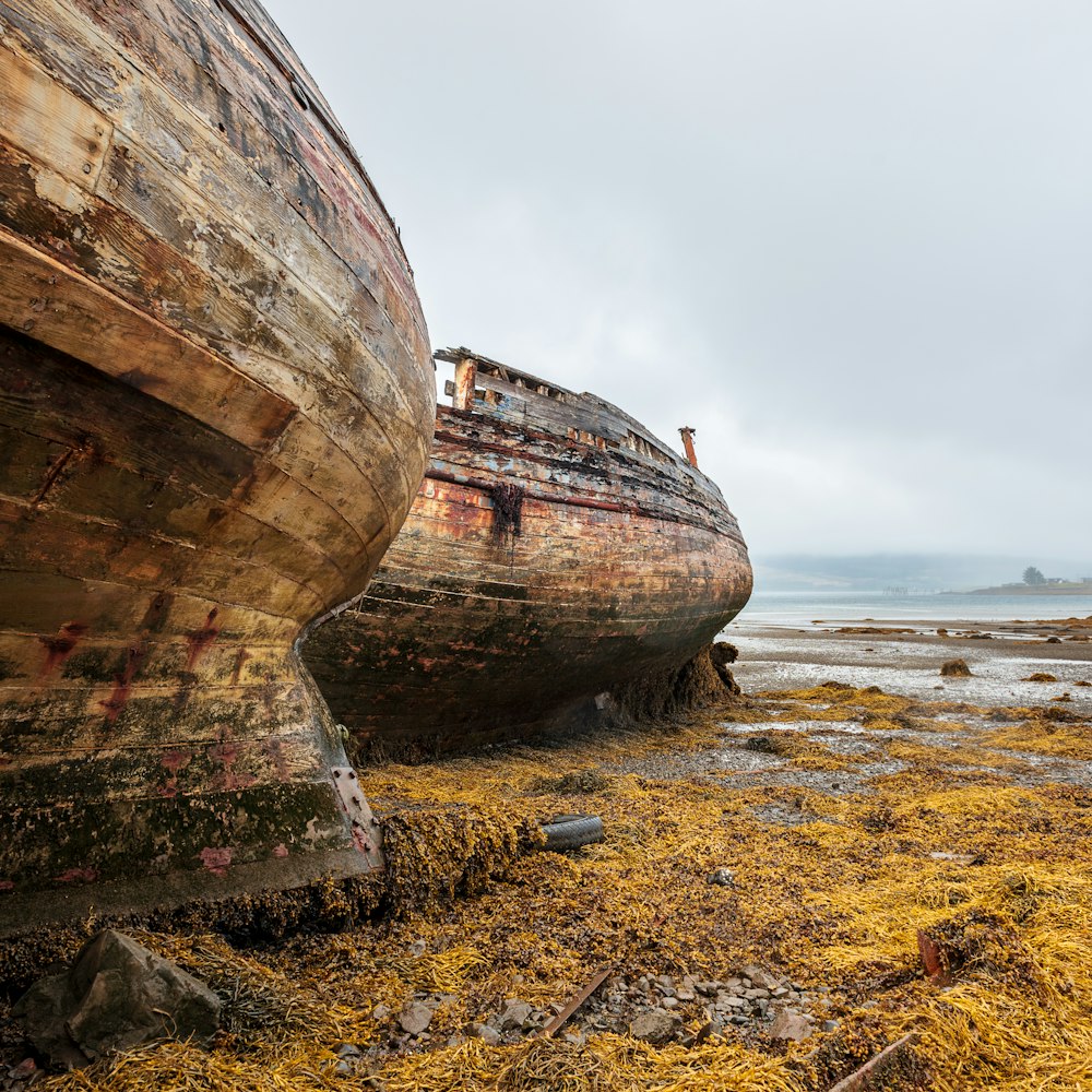 brown wooden ship on seashore during daytime