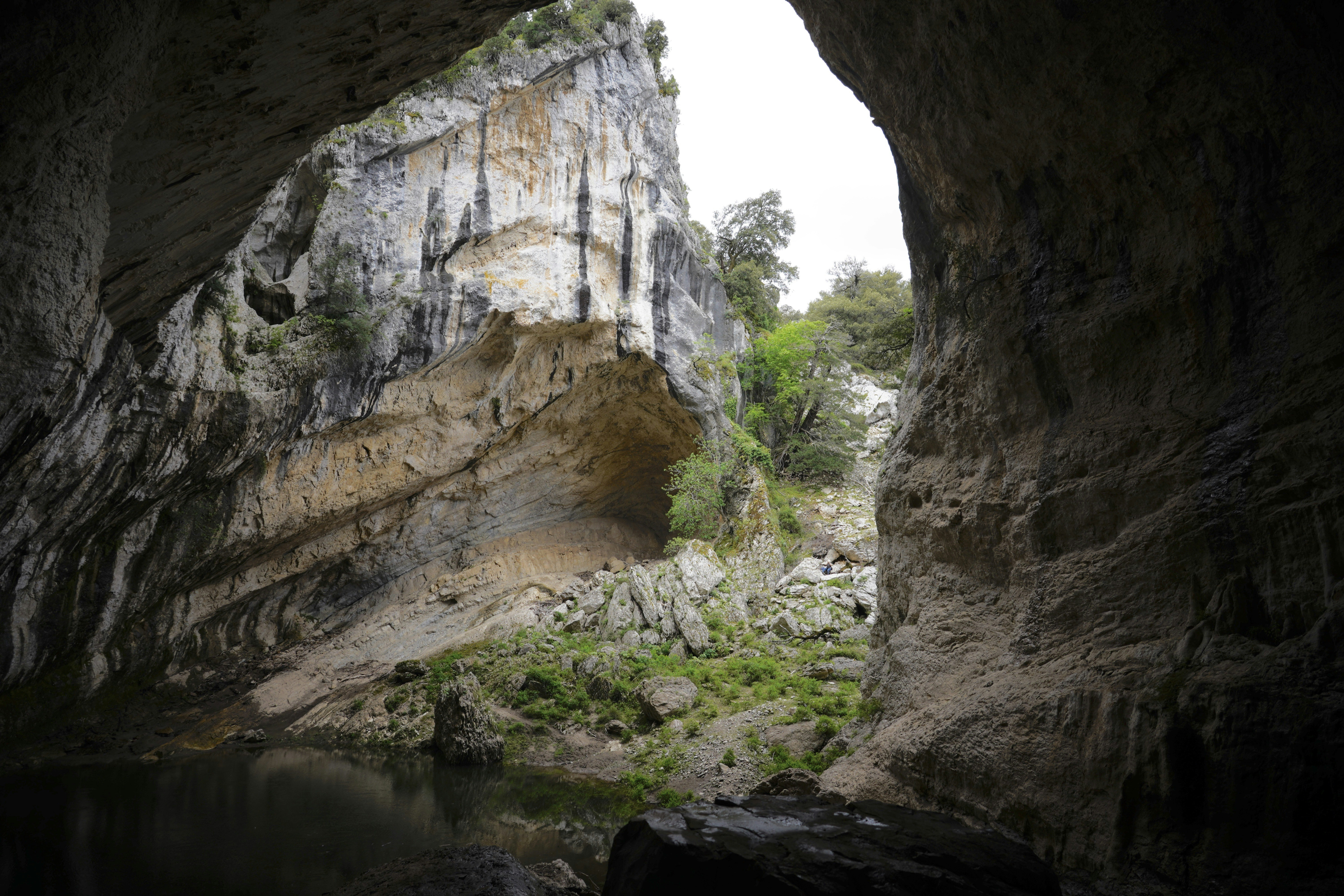 brown rock formation near body of water during daytime