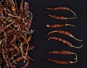 red chili peppers on black textile