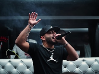 man in black nike crew neck t-shirt wearing black cap