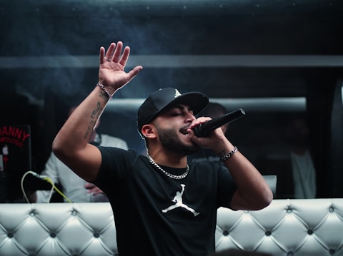 man in black nike crew neck t-shirt wearing black cap