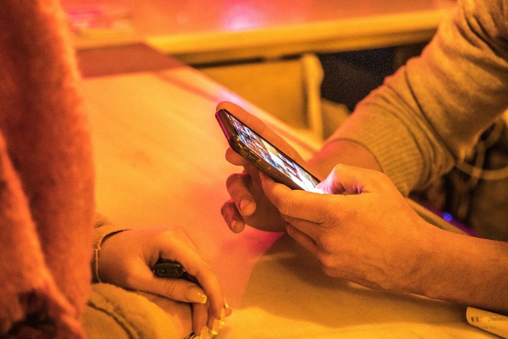 person holding silver iphone 6