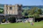 A man enjoying a sunny day at a famous historic landmark surrounded by lush greenery.