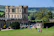 A man enjoying a sunny day at a famous historic landmark surrounded by lush greenery.