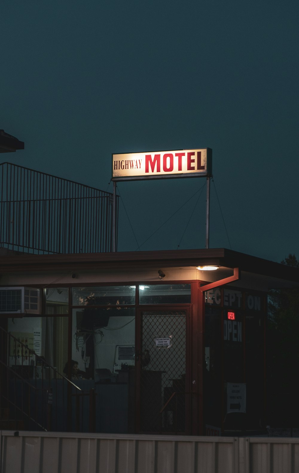 a motel sign is lit up at night