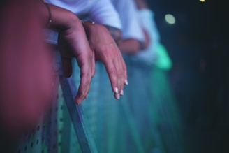 Close-up of hands scanning concert tickets at an event entrance.