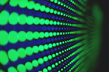 A close-up shot of glowing, futuristic soundwave patterns pulsing with vibrant colors.