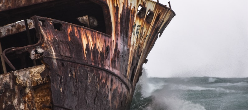 brown ship on sea waves