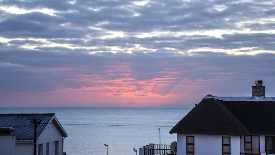 Cozy mobile home terrace with sea view at sunset.