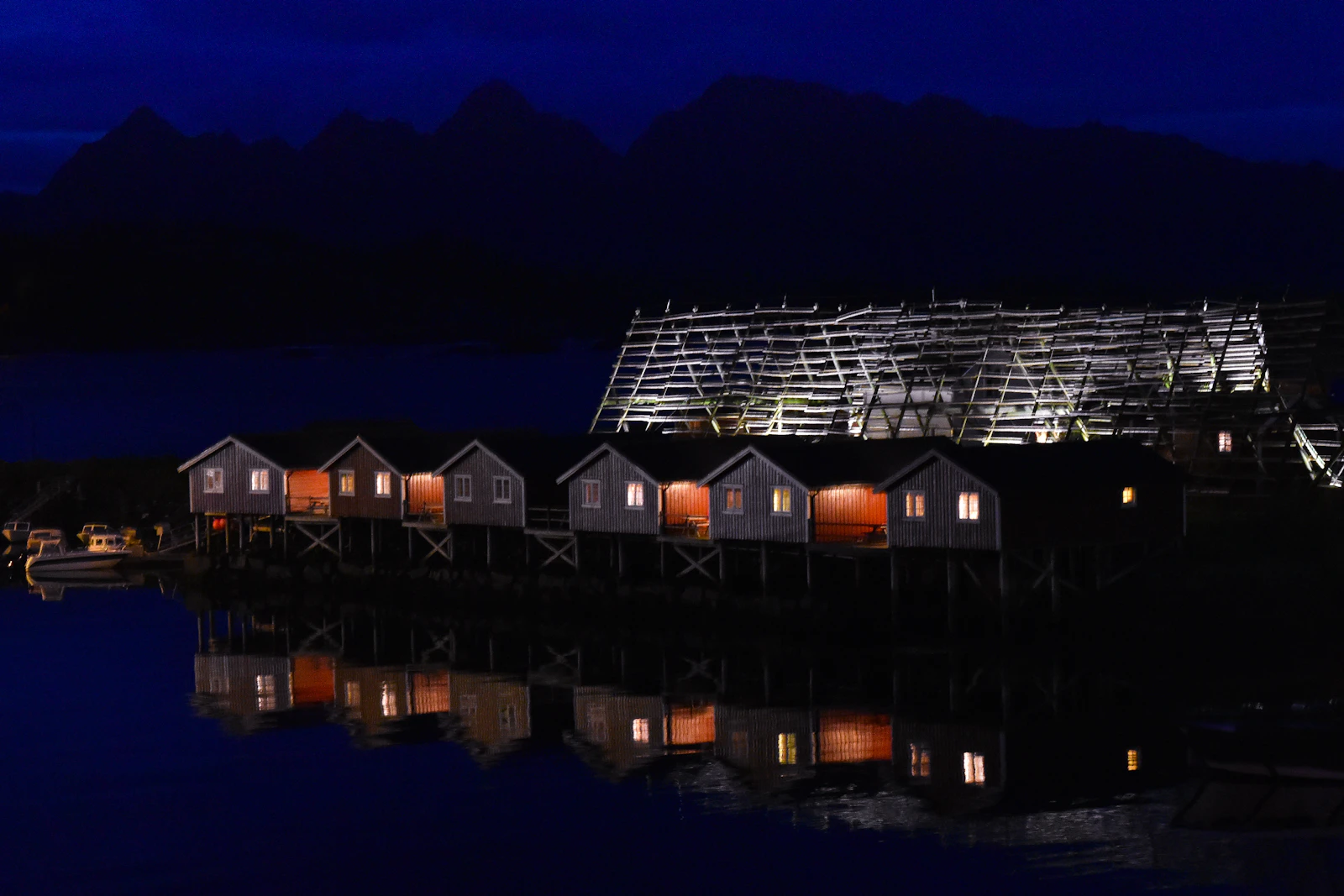 Lit waterside house on a clear winter night in Svolvær, northern Norway