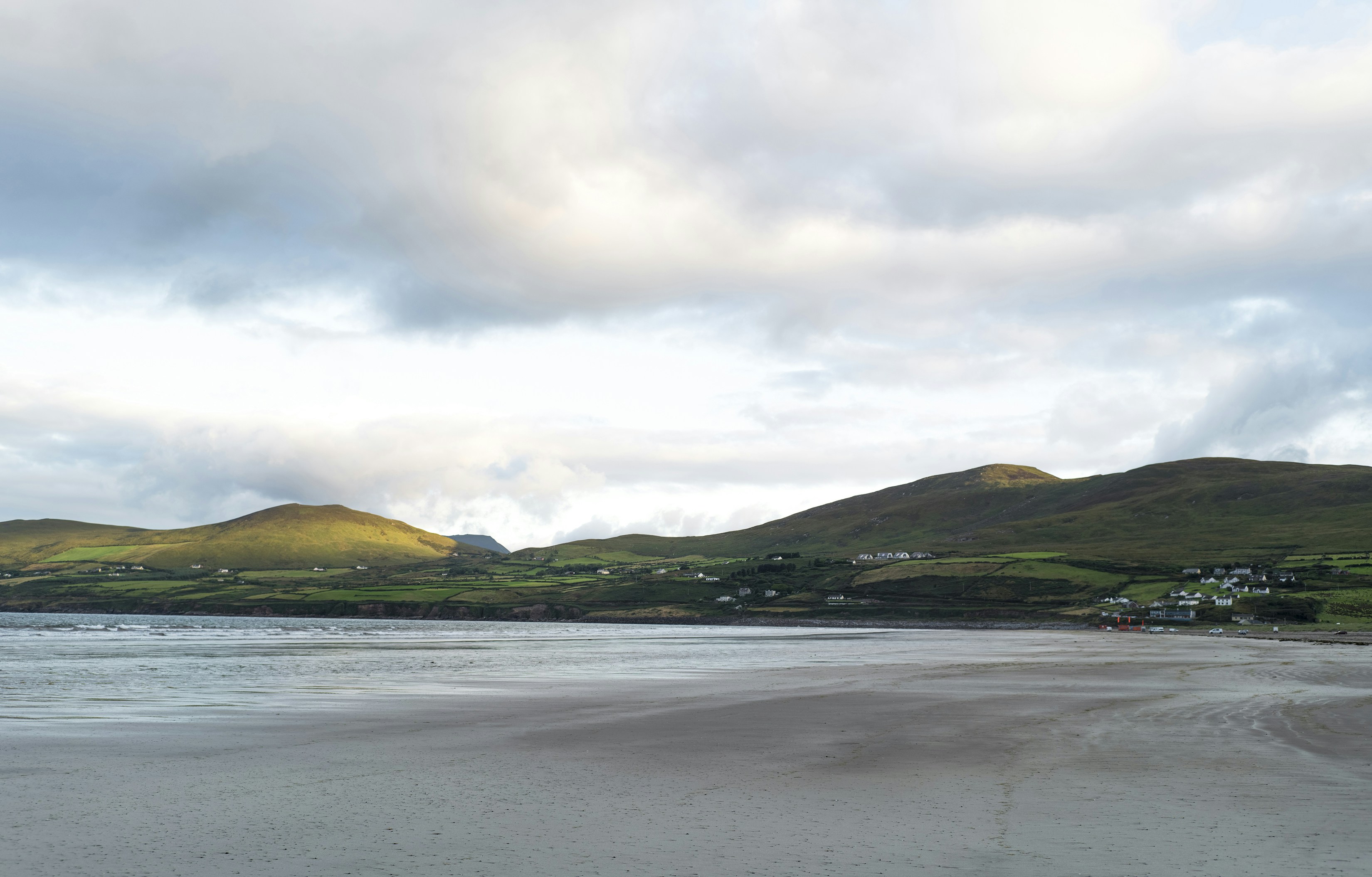 green mountain beside body of water under cloudy sky during daytime, 