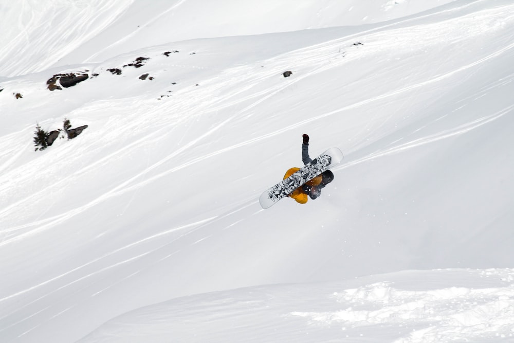 person riding ski lift on snow covered mountain during daytime