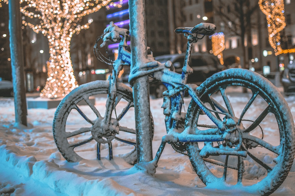 blue bicycle on white snow covered ground