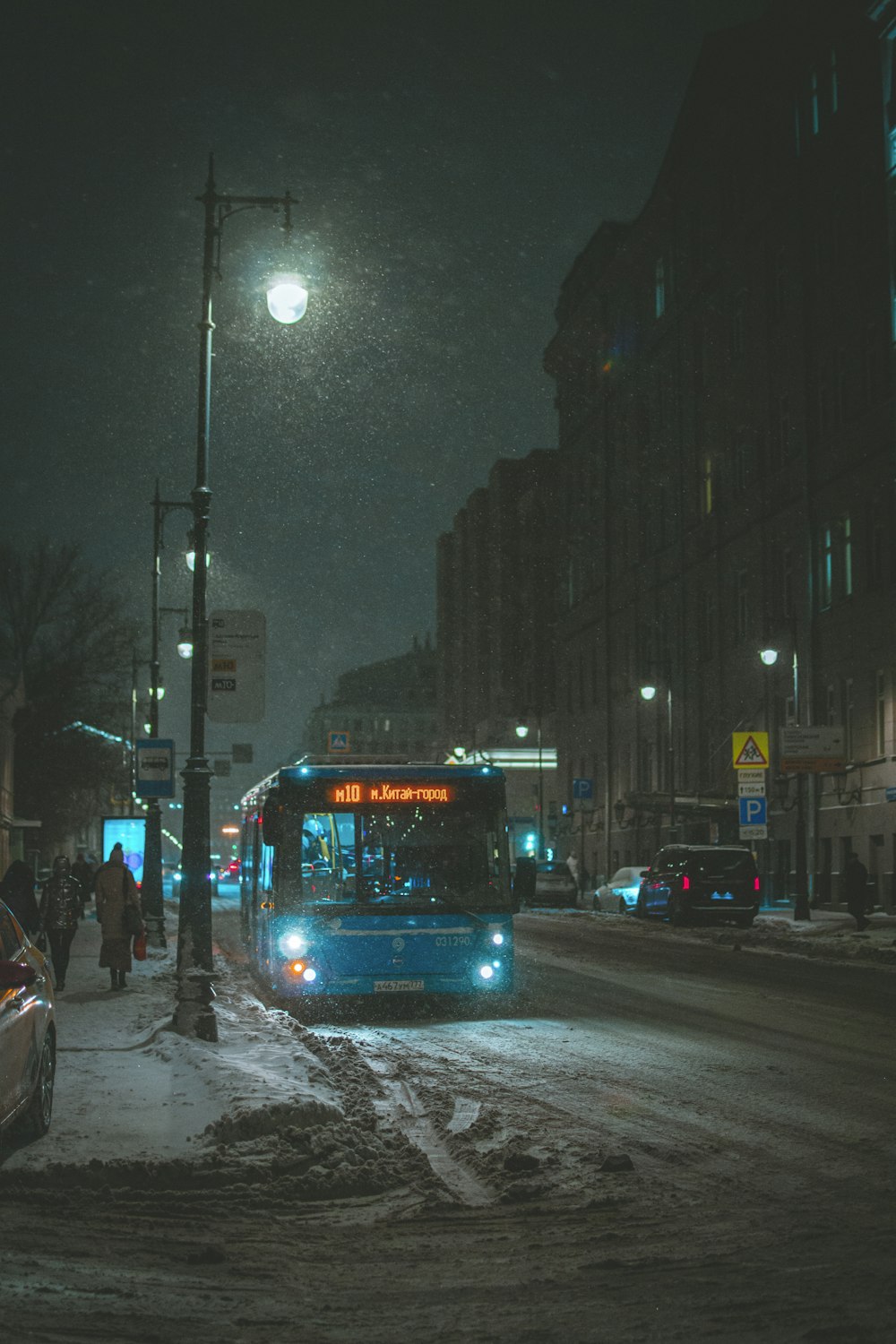 blue bus on road during night time