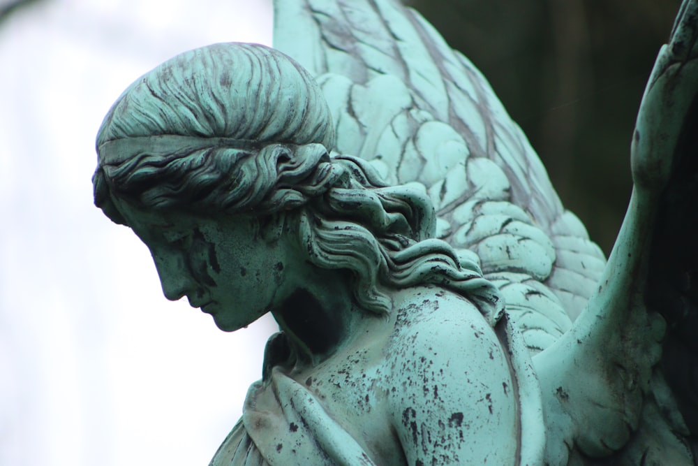 angel statue in grayscale photography