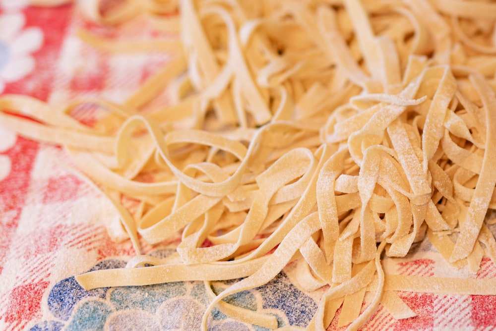 yellow pasta on white and blue textile