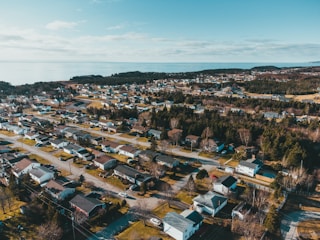A professional reviewing property documents with a Connecticut neighborhood in the background.