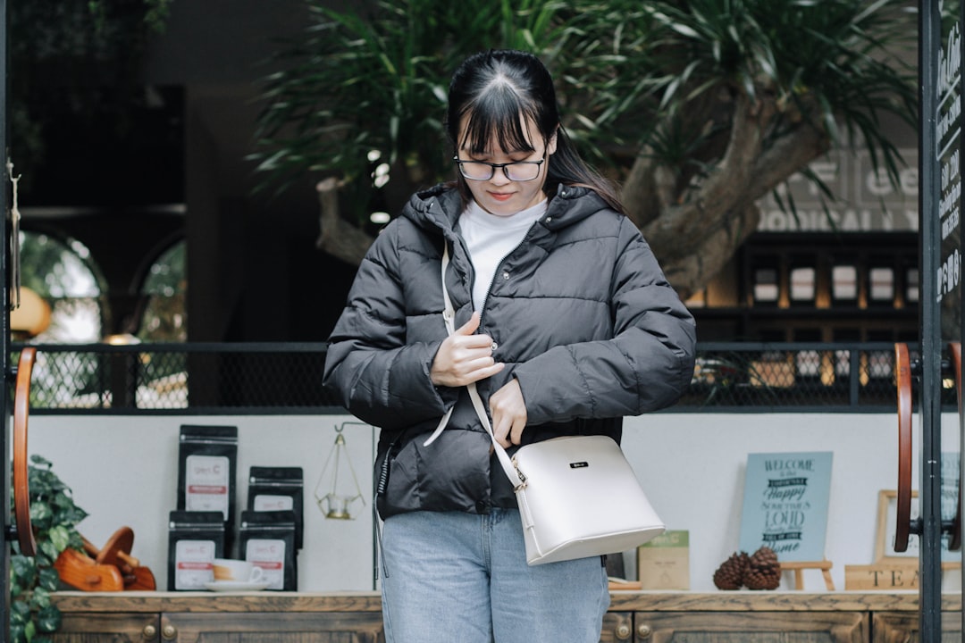 woman in black jacket holding white ipad