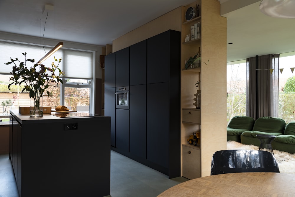 black wooden cabinet near black leather armchair