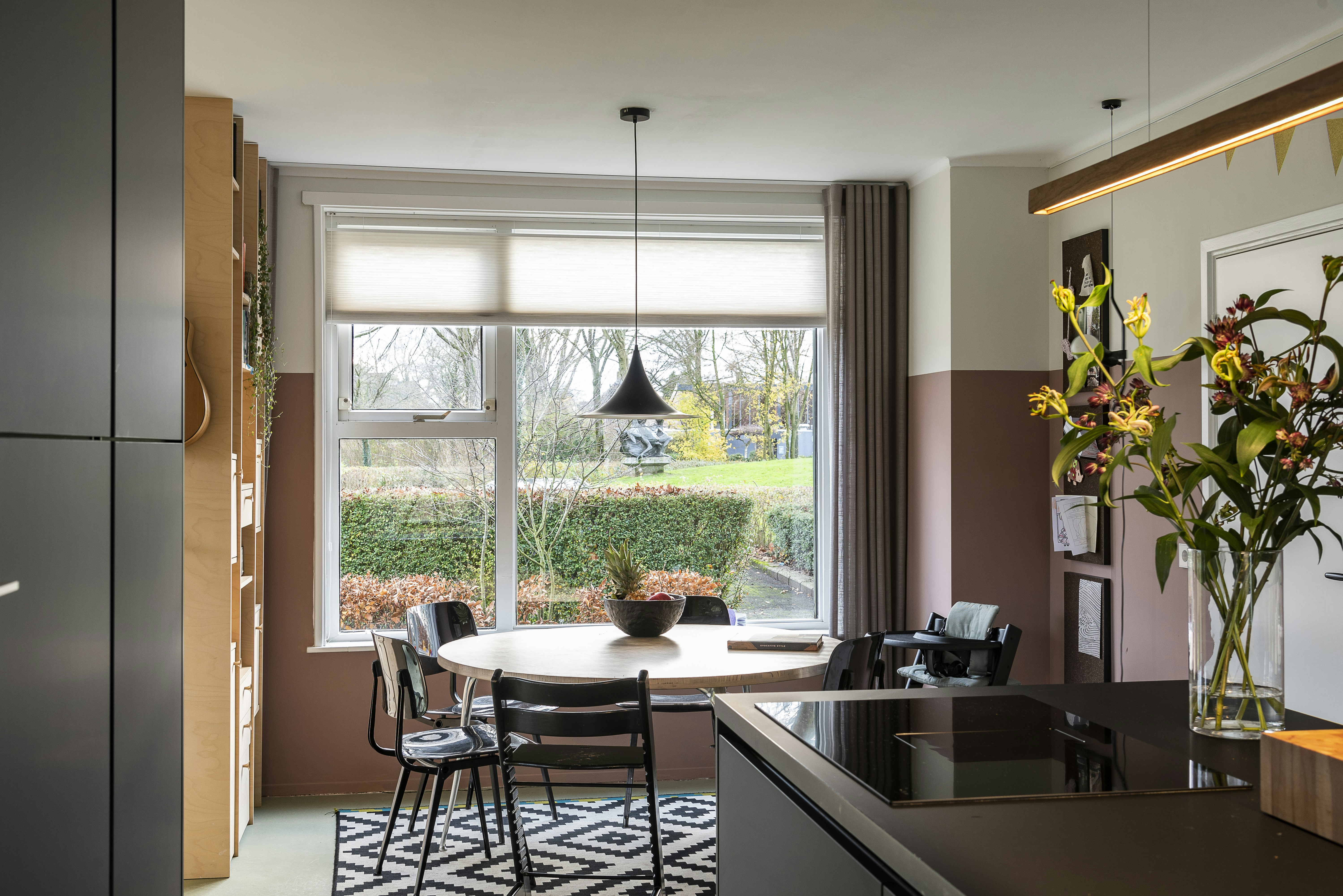 black metal framed glass top table near window