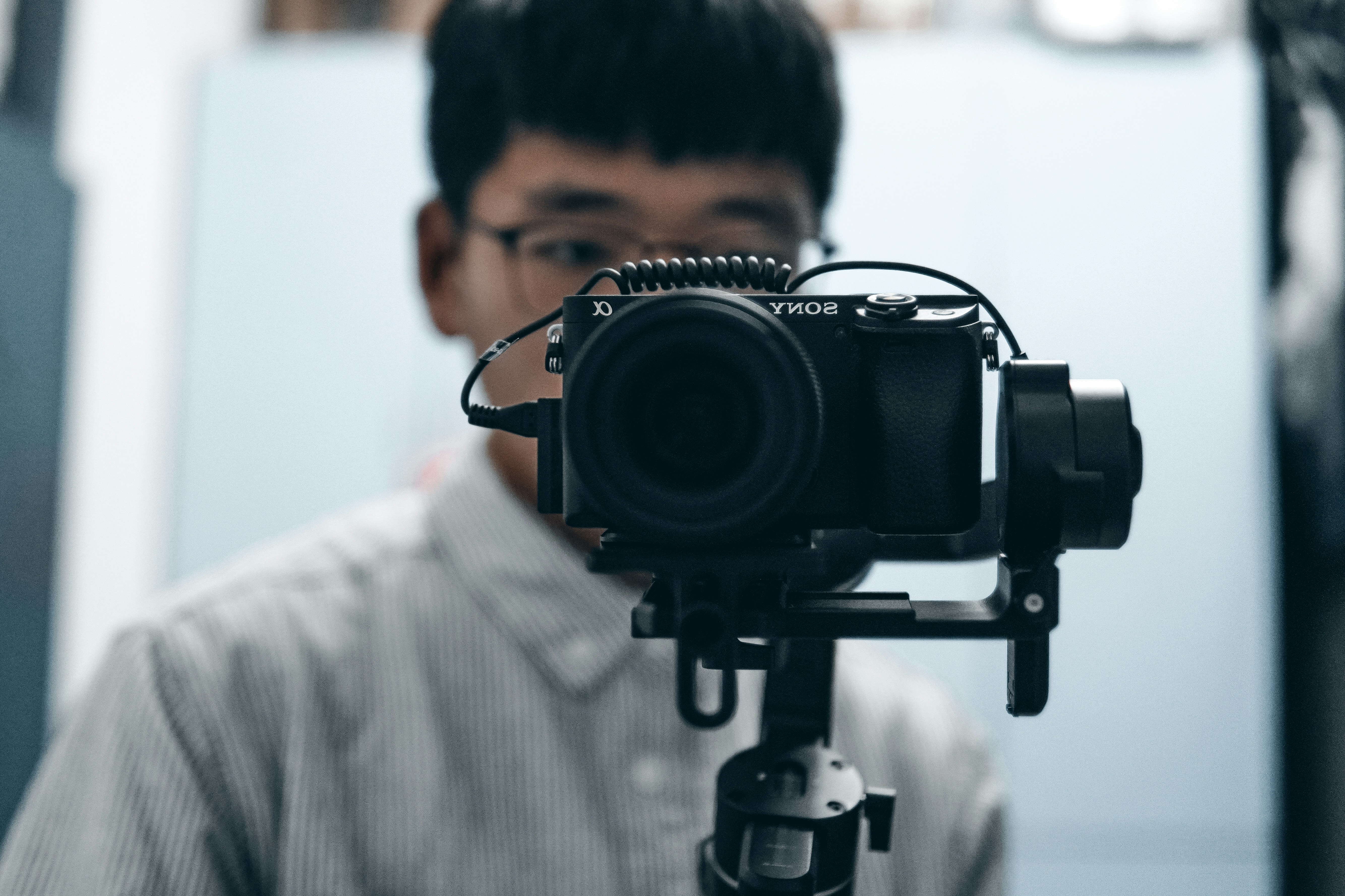 Professional videographer adjusting a camera mounted on a stabilizer.