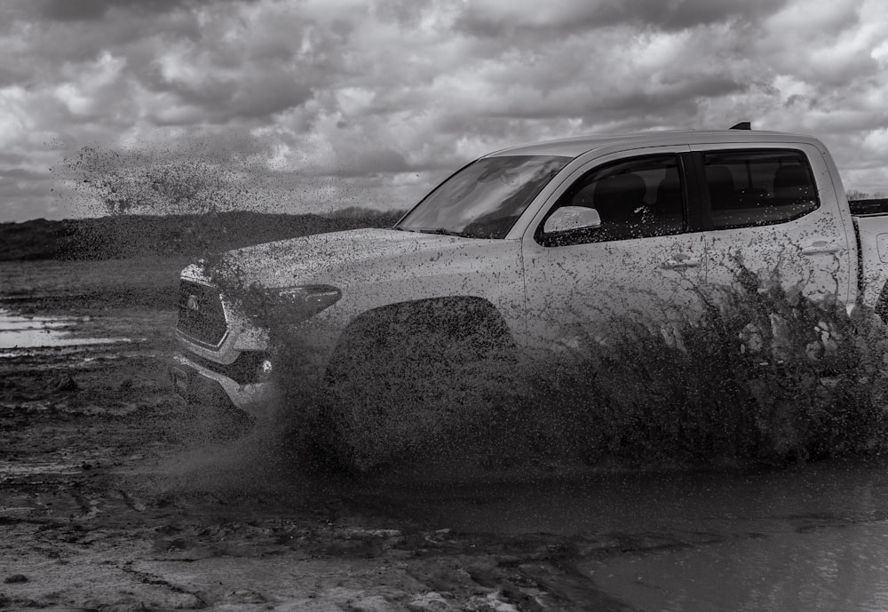 grayscale photo of car covered with snow