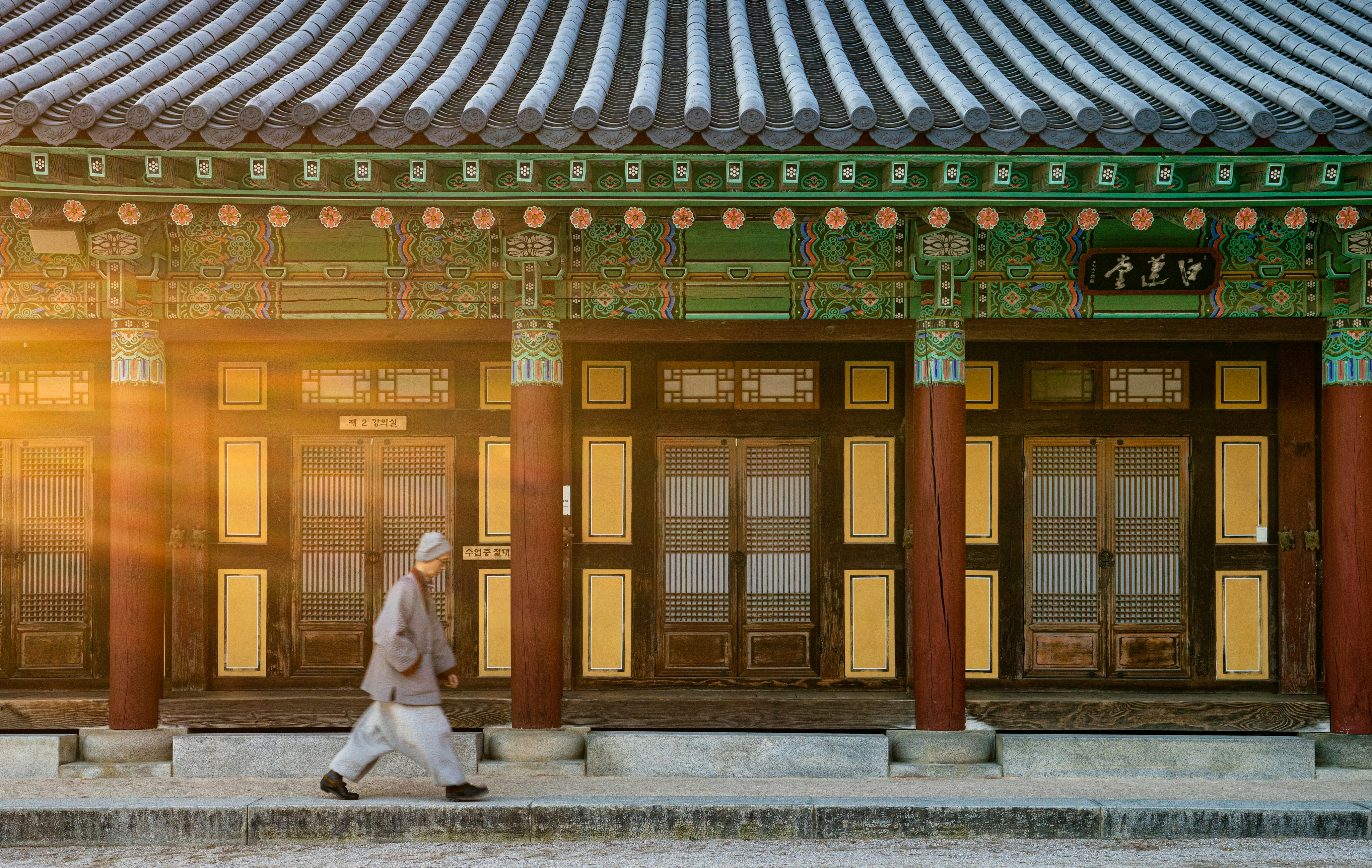 woman in white dress standing near brown wooden door, 